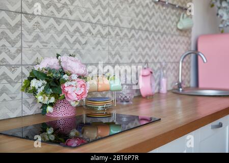 Interior of a modern kitchen set with a bouquet of flowers in a vase. background with copy space Stock Photo