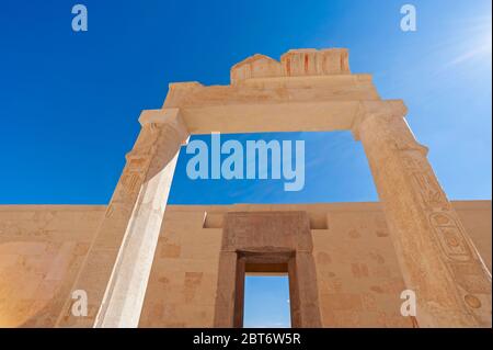 Hieroglypic carvings on doorway entrance wall at the ancient egyptian Temple of Hatshetup in Luxor Stock Photo