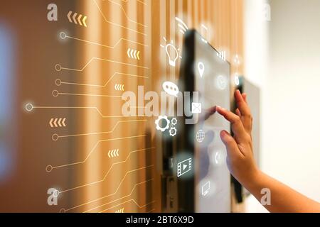 The hand that is touching the screen with communication icon floating around. Stock Photo