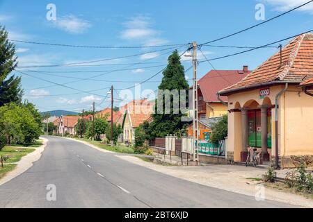 Main street Hungarian rural village Szomolya with tiny supermarket Stock Photo