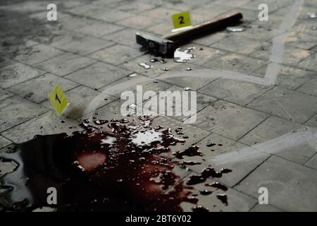 Crime scene investigation, chalk outline of victim body, blood and hammer. Stock Photo