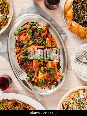Holiday table setting with Roasted Chicken side dishes and red wine Stock Photo