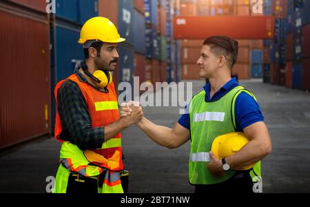 Two cargo workers join hands together for better work Stock Photo