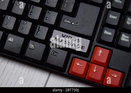 Virus Message write on keyboard isolated on laptop background Stock Photo