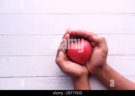 Red heart in hands, donate or charity concept Stock Photo