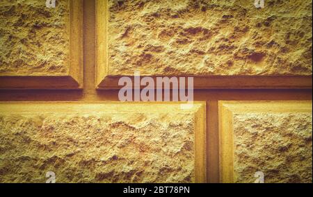 Close up of a beige stone tiled texture with a pattern. Textured background of decorative limestone bricks. Stone wall design background. Stock Photo