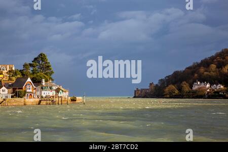 The mouth of the River Dart at Kingswear and Dartmouth with an approaching winter storm, Devon, England Stock Photo