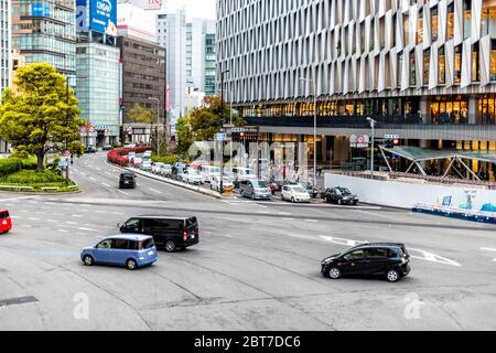 Osaka, Japan - April 13, 2019: Above view of modern buildings near station cars in traffic and hotel business signs Stock Photo