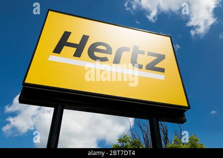 A logo sign outside of a Hertz car rental location in Silver Spring, Maryland on May 23, 2020. Stock Photo