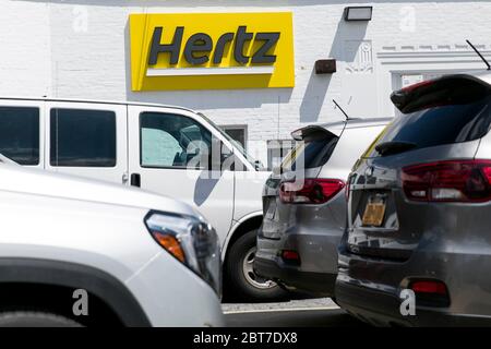 A logo sign outside of a Hertz car rental location in Silver Spring, Maryland on May 23, 2020. Stock Photo