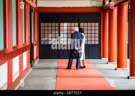 Tokyo, Japan - March 30, 2019: Corridor passage hall of Hie shrine with people tourists looking at red colorful architecture by courtyard Stock Photo