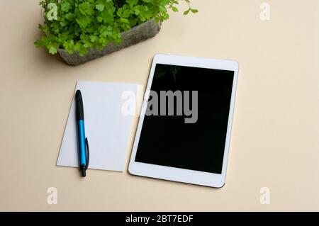 Gardening note with pen, tablet computer. mock up, fressh sprouts. Stock Photo