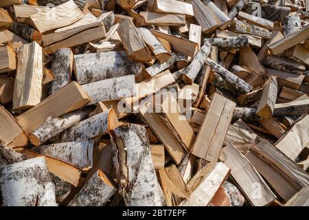 Large pile of chopped birch firewood. Stock of firewood for the winter Stock Photo