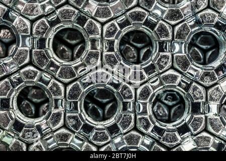 abstract background from hexagonal screw nuts Stock Photo