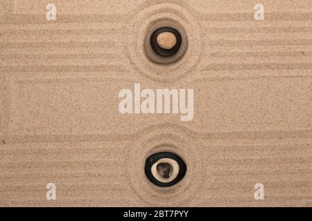 Two pyramids made of stones stand in the center of the circles of sand. Top view Stock Photo