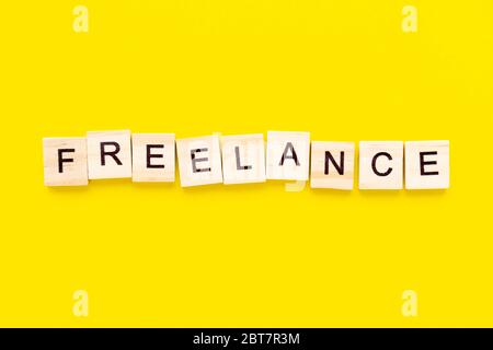Word freelance. Wooden blocks with lettering on top of gray background ...