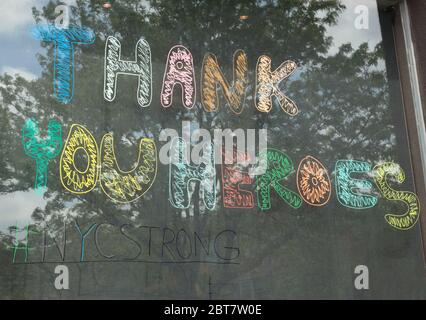 colorful painted sign on the window of a Starbucks says Thank You Heroes to health care workers during the coronavirus or covid-19 pandemic Stock Photo