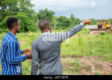 two young african men, surveying a piece of land Stock Photo