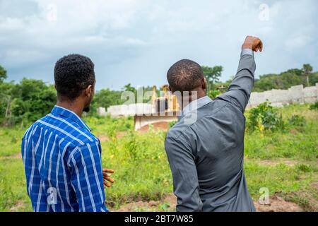 two african men, surveying a piece of land Stock Photo