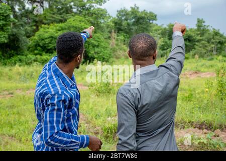 two young african business men, surveying a piece of land Stock Photo