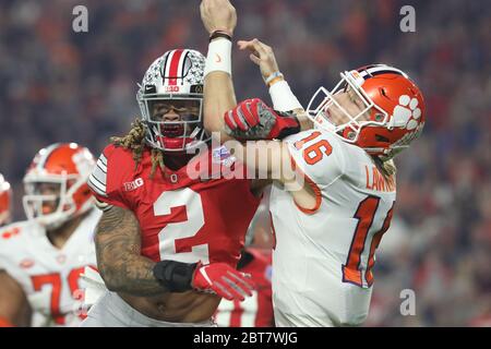 Chase Young (2), Ohio State defensive end, takes a shot at Trevor Lawrence (16), Clemson quarterback, during the 2019 CFP semi in the Fiesta Bowl. Stock Photo