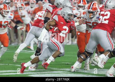 JK Dobbins (2), Ohio State running back, looks for space during the Buckeyes 2019 CFP semifinal football game against Clemson in the Fiesta Bowl. Stock Photo