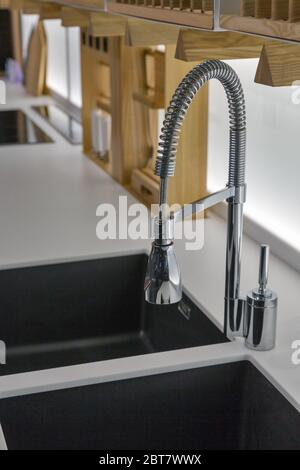 Sink and chrome faucet in modern kitchen closeup Stock Photo
