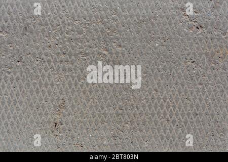 seamless old flat and dry concrete texture with diamond pattern and light signs of erosion Stock Photo