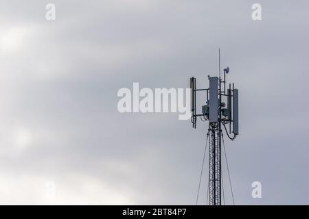 Cell phone broadcasting pole. mobile communications metal tower. 5g gsm antenne. Stock Photo