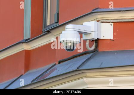 360 degrees security surveillance camera. Camcorder on a house corner. Modern videcam. Stock Photo