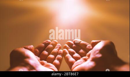 Muslim man praying. Ramadan kareem concept: Muslim prayer open two empty hands up on light background Stock Photo