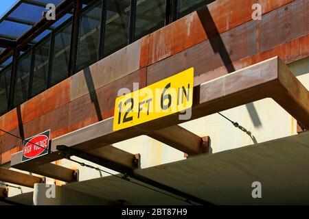 12ft 6in yellow sign above a tunnel entrance in downtown Tucson, AZ Stock Photo