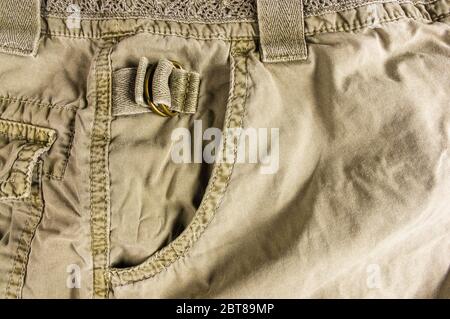 clothing items stonewashed cotton fabric texture with seams, clasps, buttons and rivets, macro Stock Photo