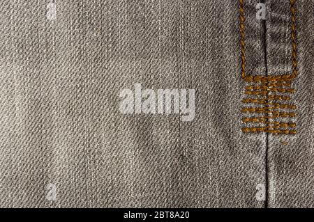 clothing items stonewashed cotton fabric texture with seams, clasps, buttons and rivets, macro Stock Photo