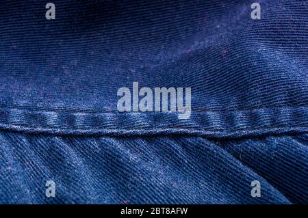 clothing items stonewashed cotton fabric texture with seams, clasps, buttons and rivets, macro Stock Photo