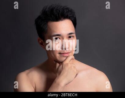 Closeup portrait of young smiling handsome man Stock Photo