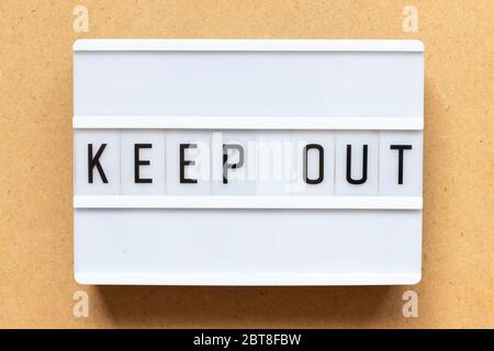 Lightbox with word keep out on wood background Stock Photo