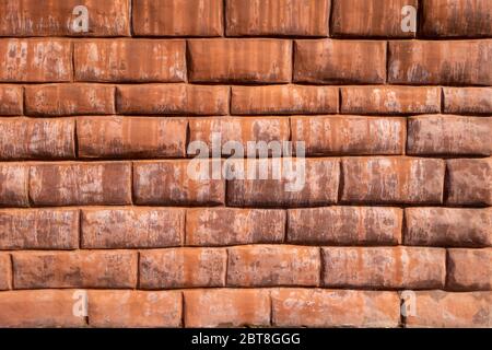 false stuck sculpted red brick with grout wall Stock Photo