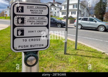 City crosswalk post button for the blind sign reads push button for accessible signal Stock Photo