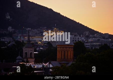 Tbilisi: Building of the Government of Georgia and Mount Mtatsminda at twilight. Republic of Georgia Stock Photo