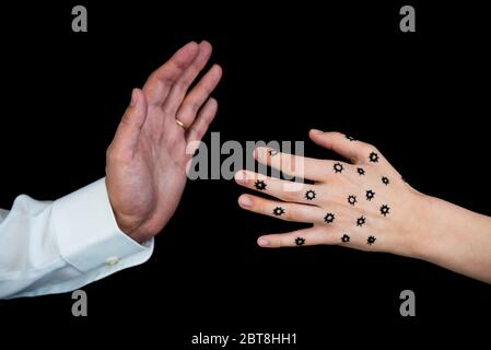 Close-up of man's hand refusing handshake from woman's hand contaminated with coronavirus COVID-19 Stock Photo