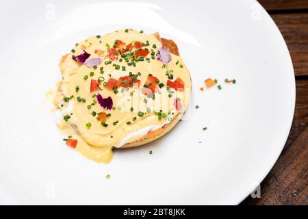 Egg benedict, Poached Egg Royal with Smoked Salmon and Tomato Hollandaise, international gourmet cuisine traditional breakfast of New York. Restaurant Stock Photo