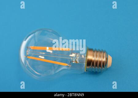 Filament LED bulb clear on a blue background Stock Photo