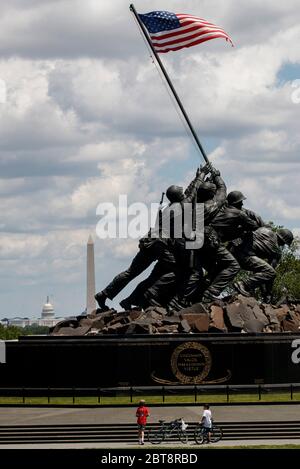 Washington, DC, Virginia, USA. 23rd May, 2020. Children visit the U.S. Marine Corps War Memorial in Arlington, Virginia, the United States on May 23, 2020. The U.S. Centers for Disease Control and Prevention (CDC) acknowledged it had mixed together results from COVID-19 viral and antibody tests on its website, according to U.S. media reports. Eleven states also confirmed mixing viral and antibody test results, CNN reported on Friday. Credit: Ting Shen/Xinhua/Alamy Live News Stock Photo
