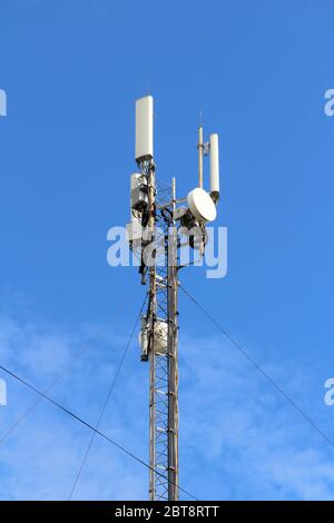 Base station mobile network antenna on a steel structure mast with a repeater. 3g, 4g, 5g. Stock Photo