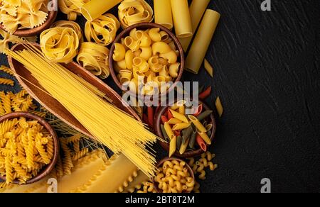 Different pasta types on black background with copy space for text Stock Photo