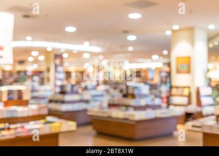 De focused blur image of a bookstore with lights and book stand. Bookstore background. Retro effect. Stock Photo