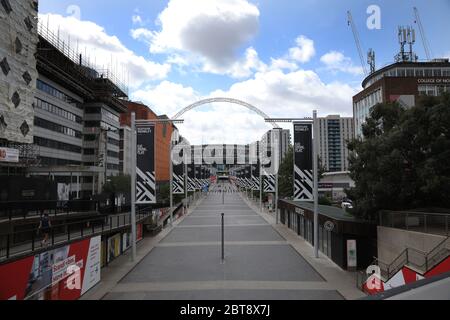 Day Sixty One of Lockdown, in London. Wembley Way is very quiet today, compared to the tens of thousands of football fans who would normally be filling it on Cup Final day. Today would have seen the Emirates FA Cup Final being played at Wembley Stadium, but due to the Coronavirus pandemic, it has been postponed. Even though there has been a partial lifting of lockdown, there are still many shops that have to remain closed, including barbers and hairdresser salons, but more people seem to be out and about on the streets and in the countryside. COVID-19 Coronavirus lockdown, Wembley Stadium, Wem Stock Photo