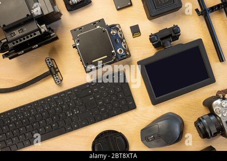 Overhead view of computer parts and filming accessories on table Stock Photo