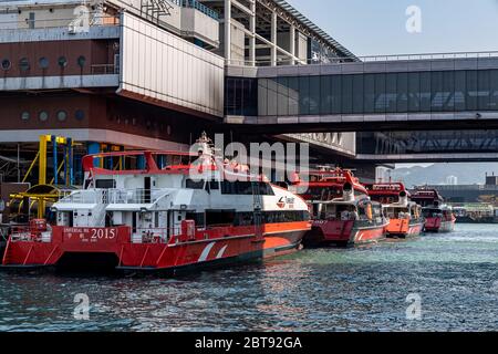 Sheung Wan, Hong Kong  - February 22, 2020 : Hong Kong - Macau Ferry Terminal at Victoria Habour. High-speed crafts are berthed at pier. All the saili Stock Photo